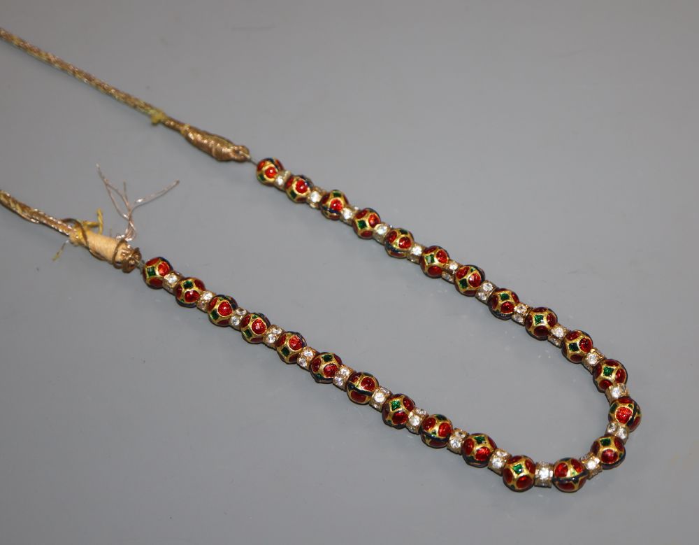 An Indian enamelled gilt metal and white paste set necklace, 74cm.